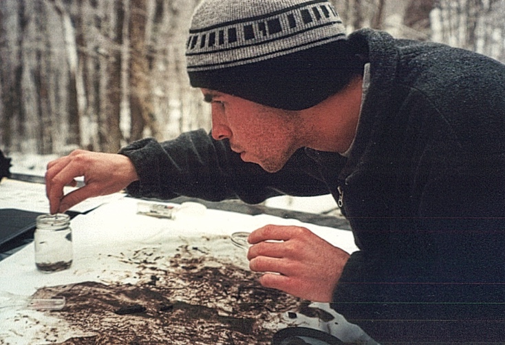 A nature foundation employee sorts out macroinvertebrates in the net.